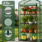A green 4-tier greenhouse with a wire mesh enclosure, shown outdoors on a patio with potted flowers, plants, and gardening supplies. A vertical text panel on the left highlights features like powder-coated steel tubes, high-quality green PE material, and a heavy-duty zipper.